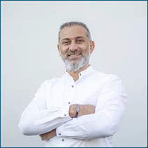 A person with his arms crossed

Description automatically generated